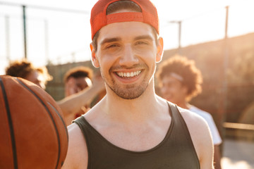 Close up of smiling man playing basketball