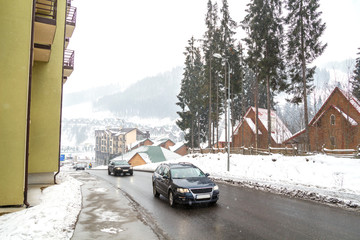 Wooden cottage house in mountain resort. Christmas winter landscape. Beautiful winter cottage covered snow.