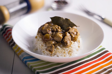 chicken and pork adobo over yellow rice, filipino food