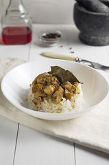 chicken and pork adobo over yellow rice, filipino food