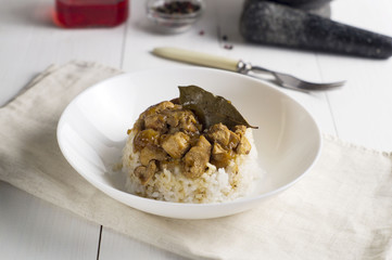 chicken and pork adobo over yellow rice, filipino food