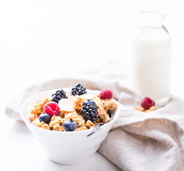 Granola Cereal bar with Strawberries blueberries and Milk on light Background . Muesli Breakfast. Healthy Food sweet dessert snack. Diet Nutrition Concept. Vegetarian food. Copy space for Text.