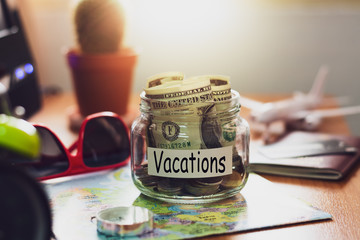 Vacation budget concept. Money for vacations savings in a glass jar.
