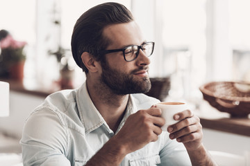 Young Handsome Man with Cup of Coffee in Cafe