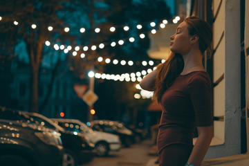 Romantic female portrait with city lights in background