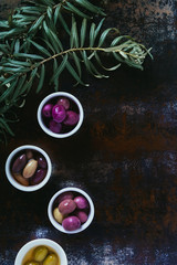 top view of olives for oil preparation in bowls on shabby surface