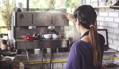 Women are making coffee. In a coffee shop.