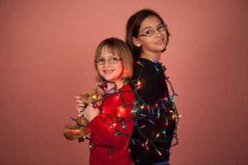 Kids wrapped up in Christmas lights for the holidays