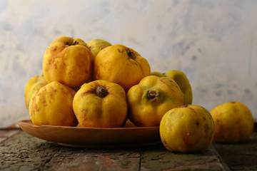 Naklejka na ściany i meble Yellow quince fruits close-up on plate