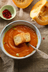Orange pumpkin soup in bowl