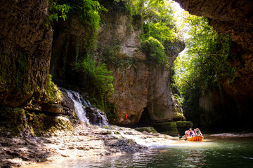 Martvili, Georgia - June 22 2018: People in boat and waterfall in Martvili Canyon