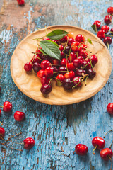 Fresh cherry on wooden plate