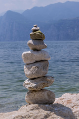 Stones stacked on a background of lake and mountains