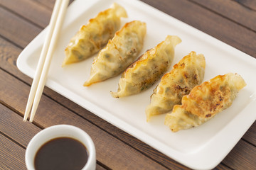 Pan Fried Dumpling, with sauce. Asian food. Top view