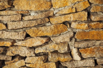 A stone wall under a bridge