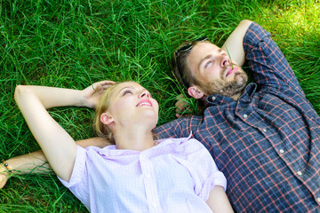 Nature fills them with freshness and peace. Man unshaven and girl lay on grass meadow. Closer to...