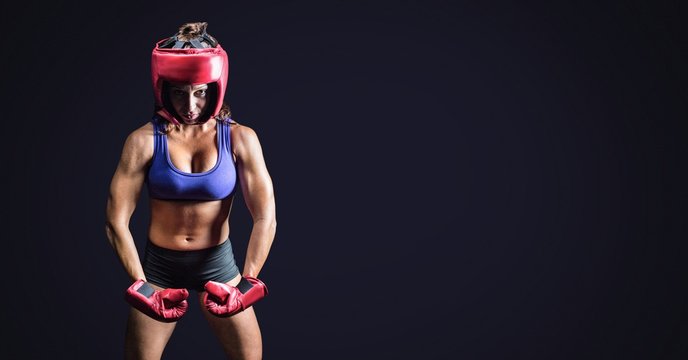 Female boxer with blank dark background
