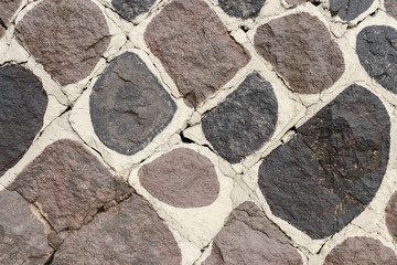 Fragment of a stone wall stained with spots