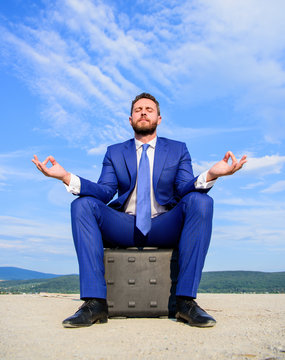 Businessman Formal Suit Sit On Briefcase And Meditating Outdoors. Entrepreneur Find Minute To Relax And Meditate. Man Try To Keep His Mind Clear. Relaxation Technique. Keeping Calm Inside His Soul