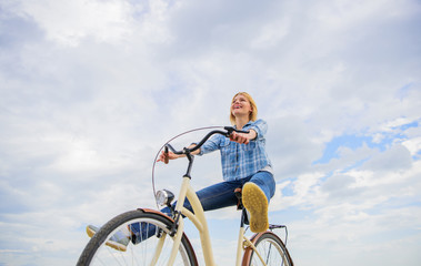 Girl rides bicycle sky background. Woman feels free while enjoy cycling. Cycling gives you feeling...