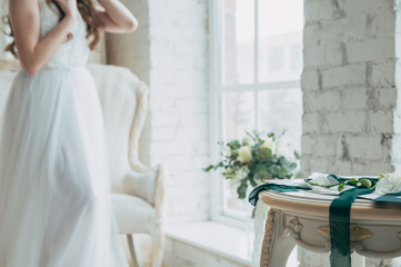 Wedding. A table with a decor on the background of a bride in a white dress.