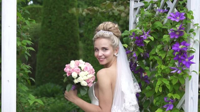 beautiful image of the bride with a bouquet of flowers in a beautiful garden