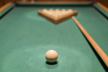 billiard table with balls and cue stick. gambling table with russian billiard set and cue