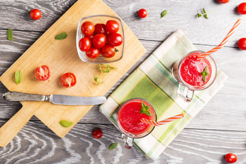 Cups of glass with tomato juice drink