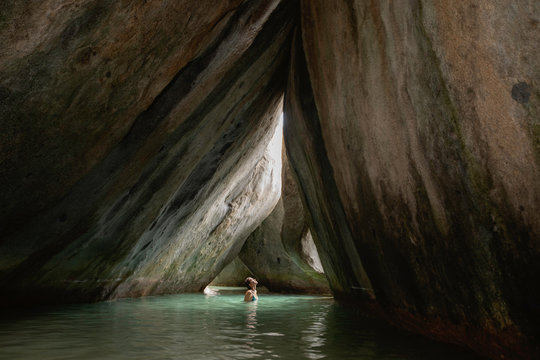 Young woman exploring flooded grotto, Virgin Gorda, British Virgin Islands