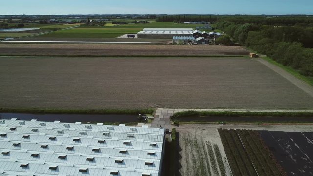 Dutch farmland and greenhouse. Aerial footage.