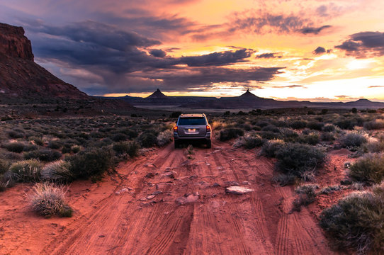 Off road vehicle facing sunset, Indian Creek, Moab, Utah, USA