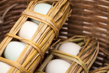 Eggs come wrapped in straw at the market in Xinjie, China.