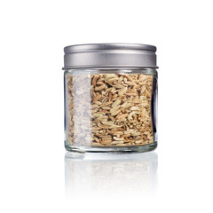 fennel seeds in a glas with metal lid, isolated on white