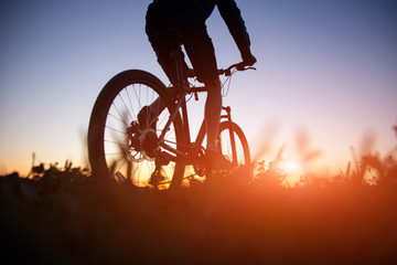 Fototapeta na wymiar Silhouette of man riding bicycle in sunset