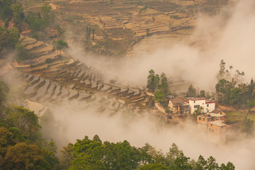 The Cloud Sea Lifts Around a Small Village in the Rice Terraces of Yuanyang Provence, China