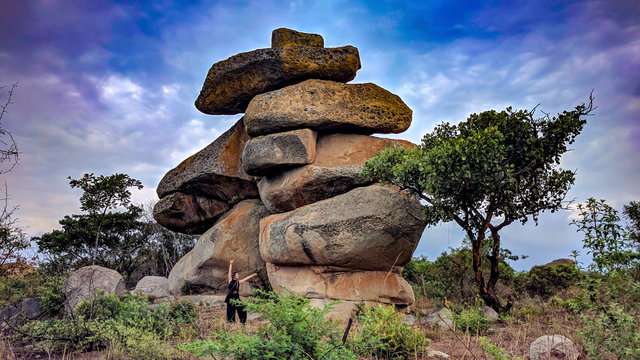 A balancing rock with a woman, Epworth, Harare, Zimbabwe