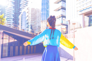 back view young woman outdoor back light arms raised - freedom, victory, satisfaction concept
