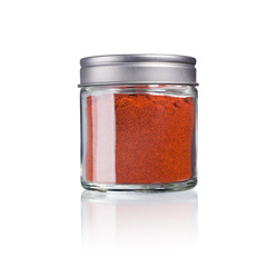 paprika powder in a glas with metal lid, isolated on white