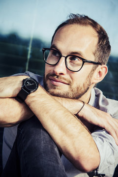 Portrait of bearded man wearing glasses and writs watch