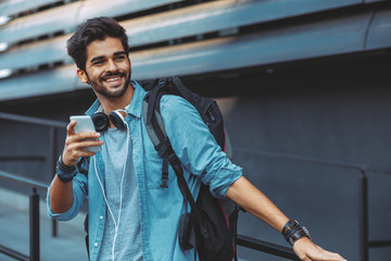 Young handsome man using smartphone outdoor