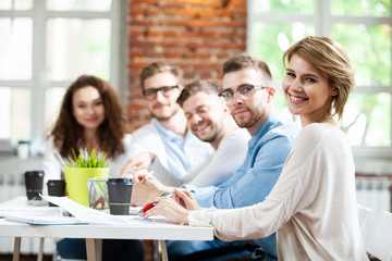 Group of young multiracial people working in modern light office. Businessmen at work during meeting.