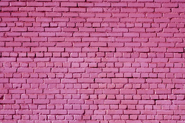 Pink color old grungy brick wall surface.