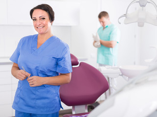 dentist in medical center with assistant