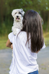 Beautiful Smiling Woman Hugging  Her Cute Havanese Dog .Pet and Owner Outdoor