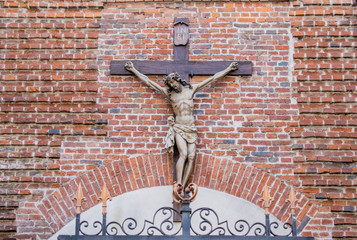 Crucifixion of Jesus on a brick wall background.