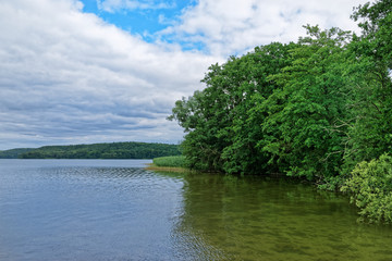 Nature scene of a lake against cloudy sky
