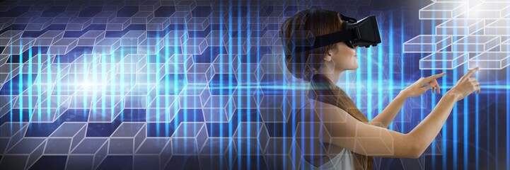Woman using tablet wearing virtual reality headset with