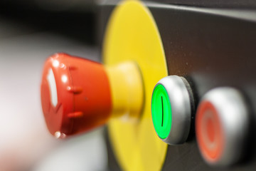 Emergency button for stopping production at any time, indoor artificial light.