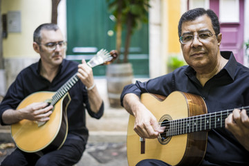 Two fado guitarists with acoustic and portuguese guitars