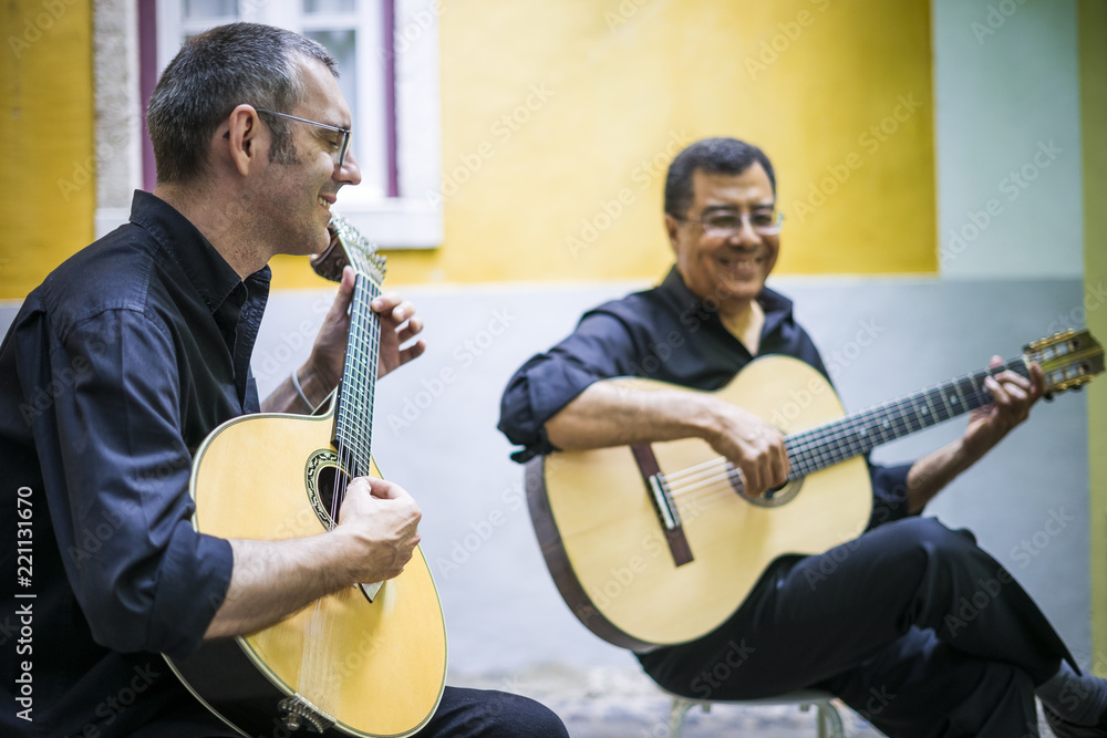 Wall mural two fado guitarists with acoustic and portuguese guitars